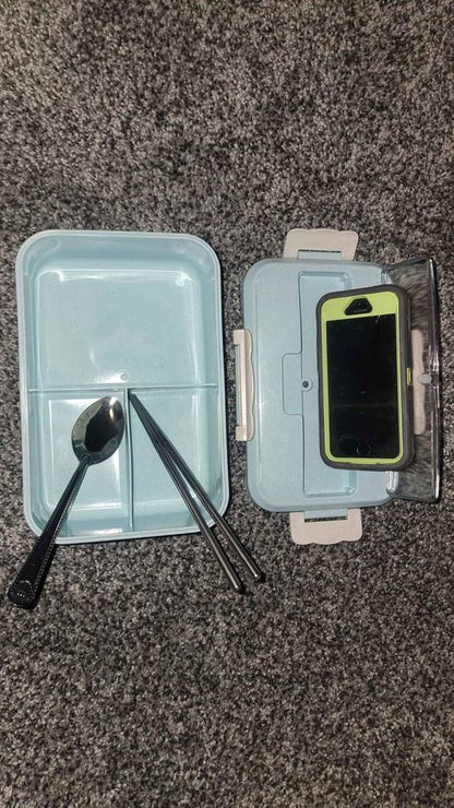 Blue bento box open with phone-sized holder and utensil set