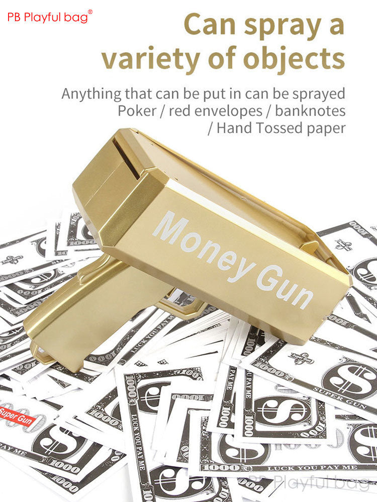 Gold money gun toy angled forward with prop cash bills underneath and tray open