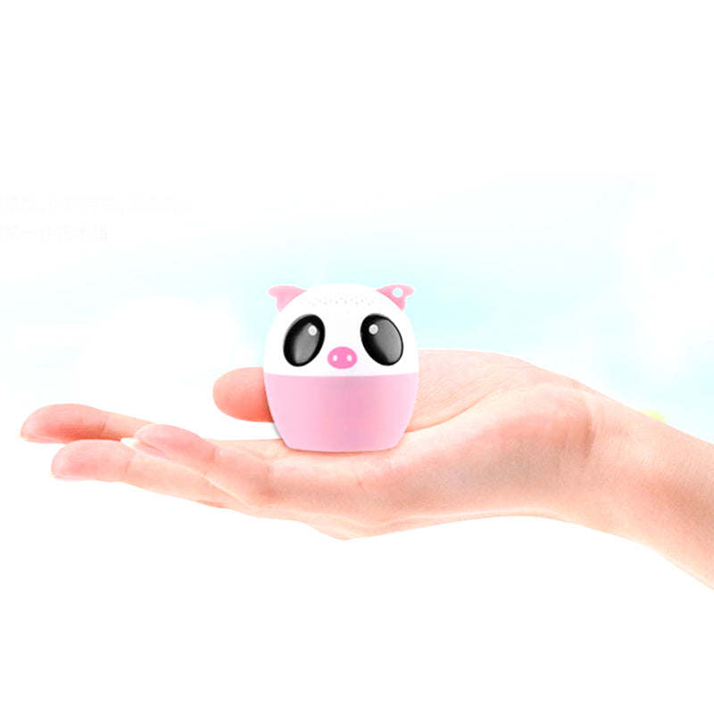 Pink-and-white animal Bluetooth speaker held in a hand
