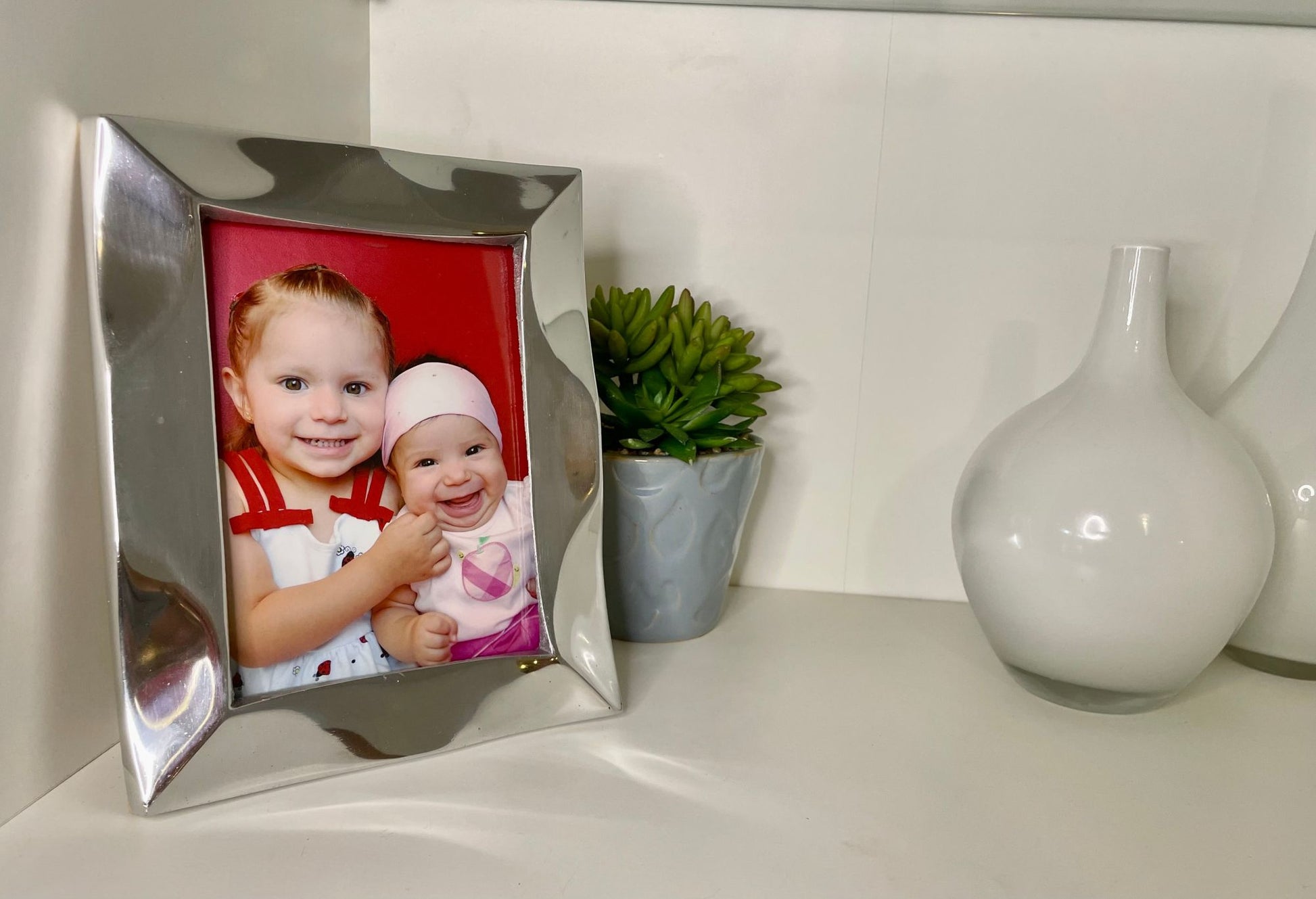 Silver tabletop picture frame displaying a child photo