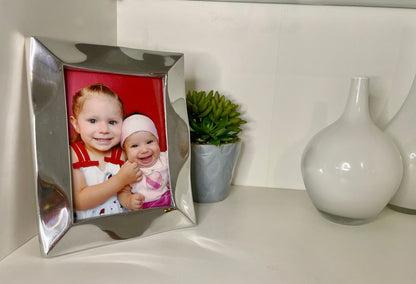 Silver tabletop picture frame displaying a child photo