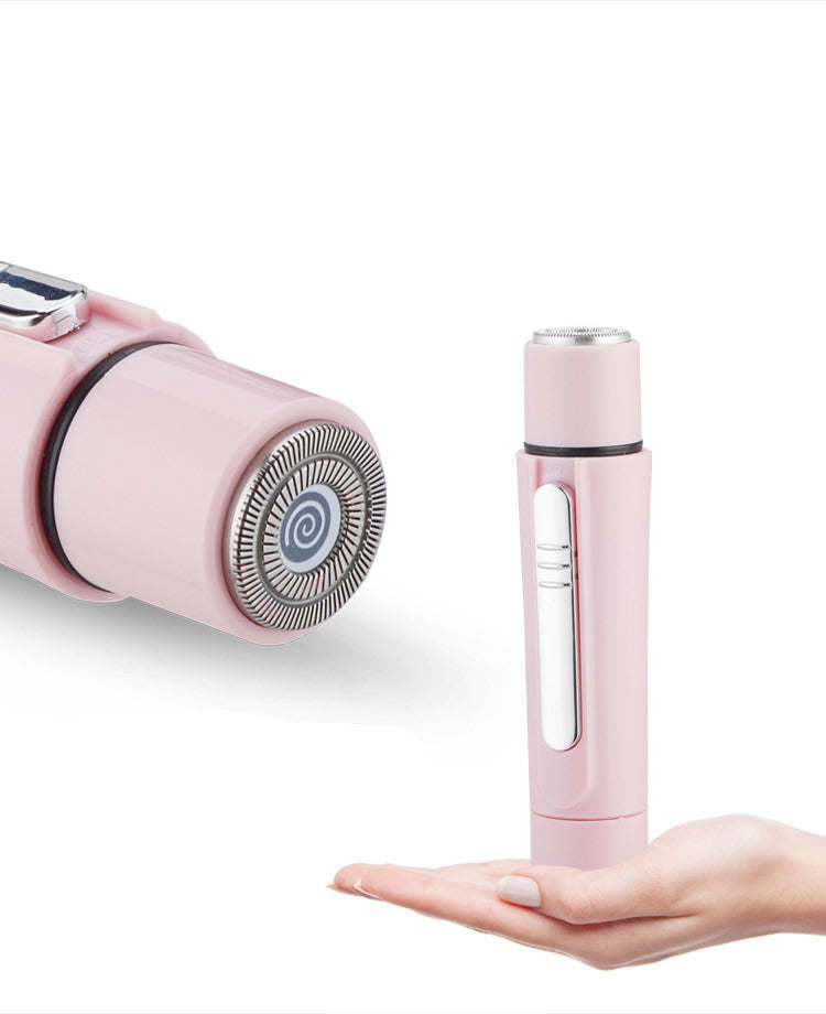Pink grooming wand with rotating head and slender handle, shown in hand