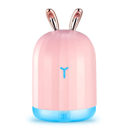 Pink bunny-shaped cool mist humidifier with blue glowing light ring on base