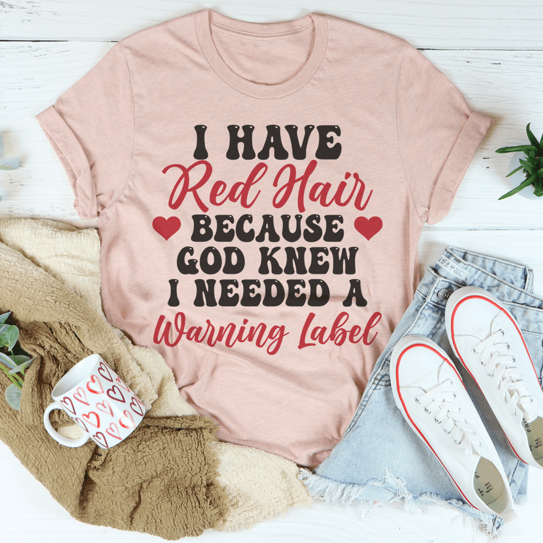 Blush pink crewneck T-shirt with “I Have Red Hair… Warning Label” lettering graphic
