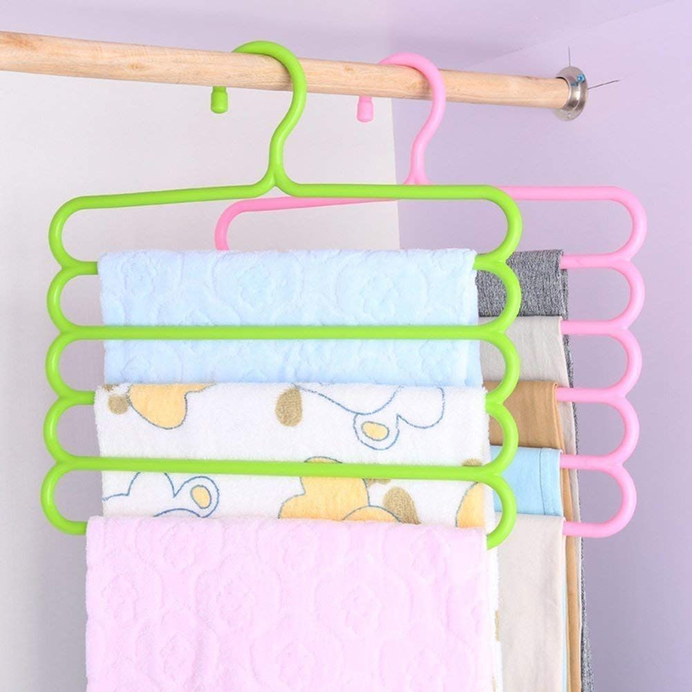Green and pink 5-layer plastic hangers holding folded towels and linens.