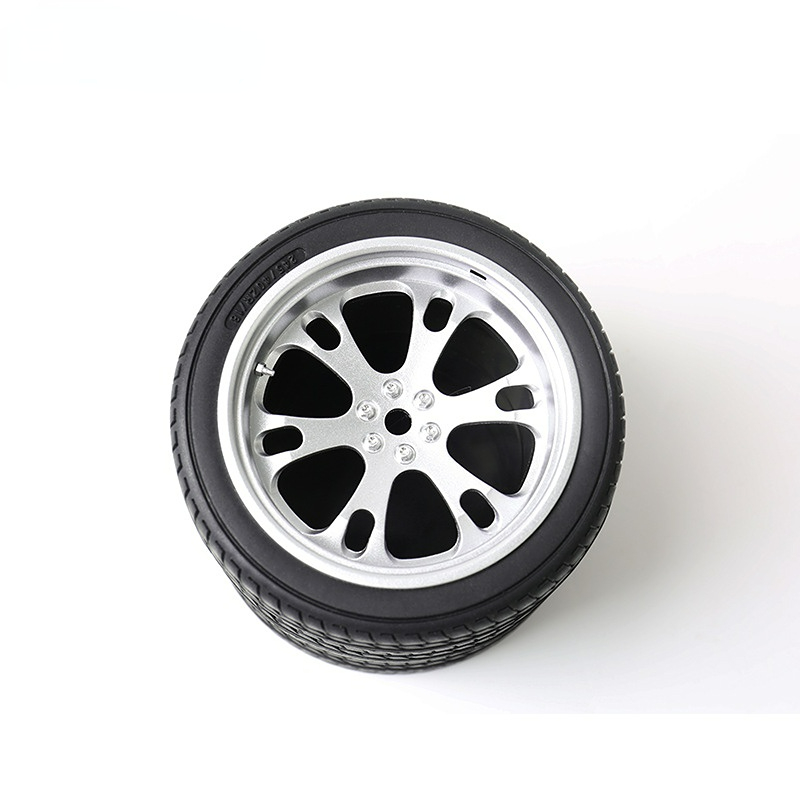 Black tire tread pen holder with silver wheel rim and spoke details