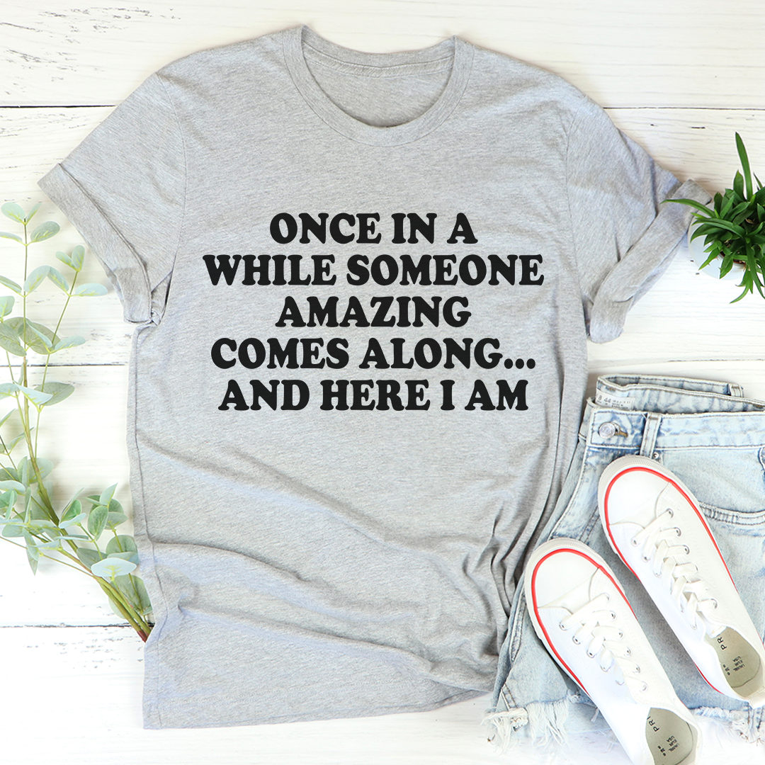 Gray crewneck T-shirt with quote print: 'ONCE IN A WHILE... AND HERE I AM'