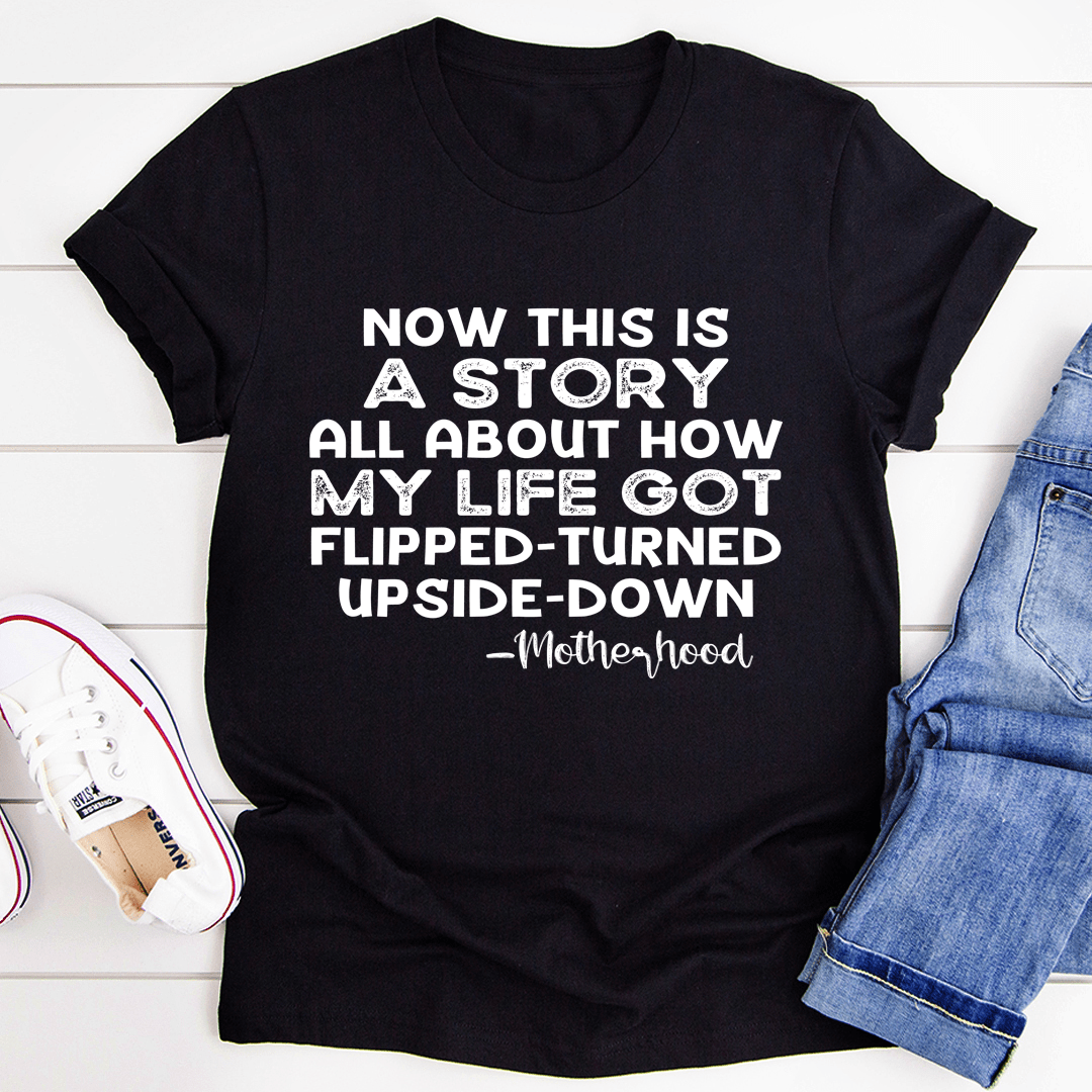 Black crew-neck T-shirt with short sleeves and bold story slogan and “Motherhood” text.