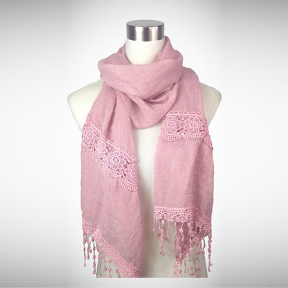 Dusty rose embroidered scarf with lace patterns and tassel fringe, centered on mannequin