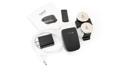 GPS mini tracker kit with charging cable, black unit, and white mounting base