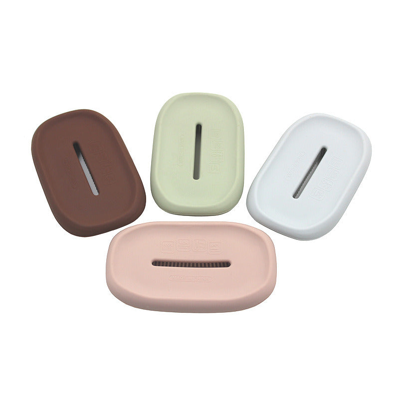 Assorted silicone soap dishes: brown, mint, white, and pink, each with drainage slots.