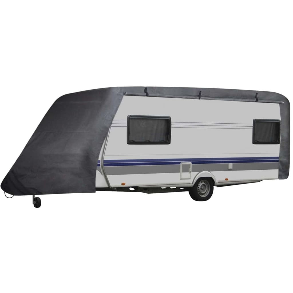 Gray caravan cover draped over a travel trailer side with window cutouts