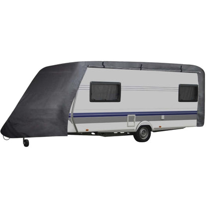 Gray caravan cover draped over a travel trailer side with window cutouts