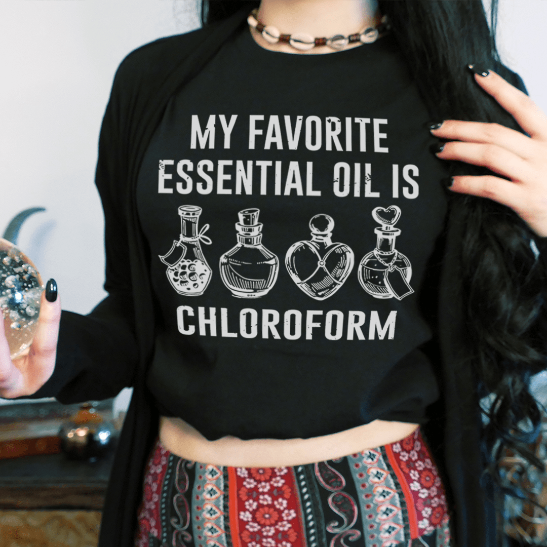 Black T-shirt on model with “MY FAVORITE ESSENTIAL OIL IS CHLOROFORM” bottle graphic