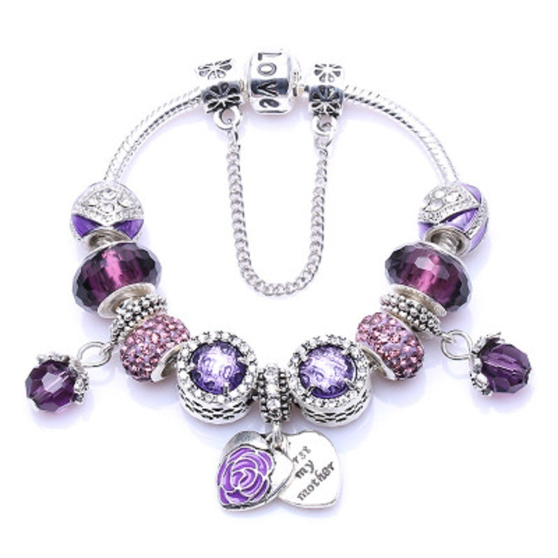 Silver charm bracelet with dark purple faceted beads, floral charm and heart pendant