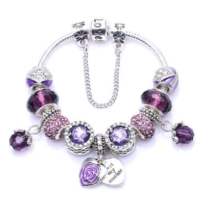Silver charm bracelet with dark purple faceted beads, floral charm and heart pendant