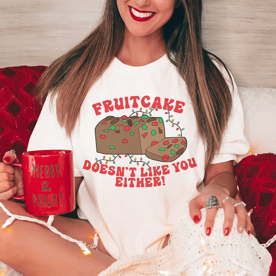 White short-sleeve crewneck T-shirt, fruitcake cartoon and slogan centered on chest