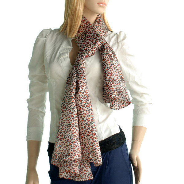 Large silk leopard-print scarf worn around neck, natural base with dark and orange spots