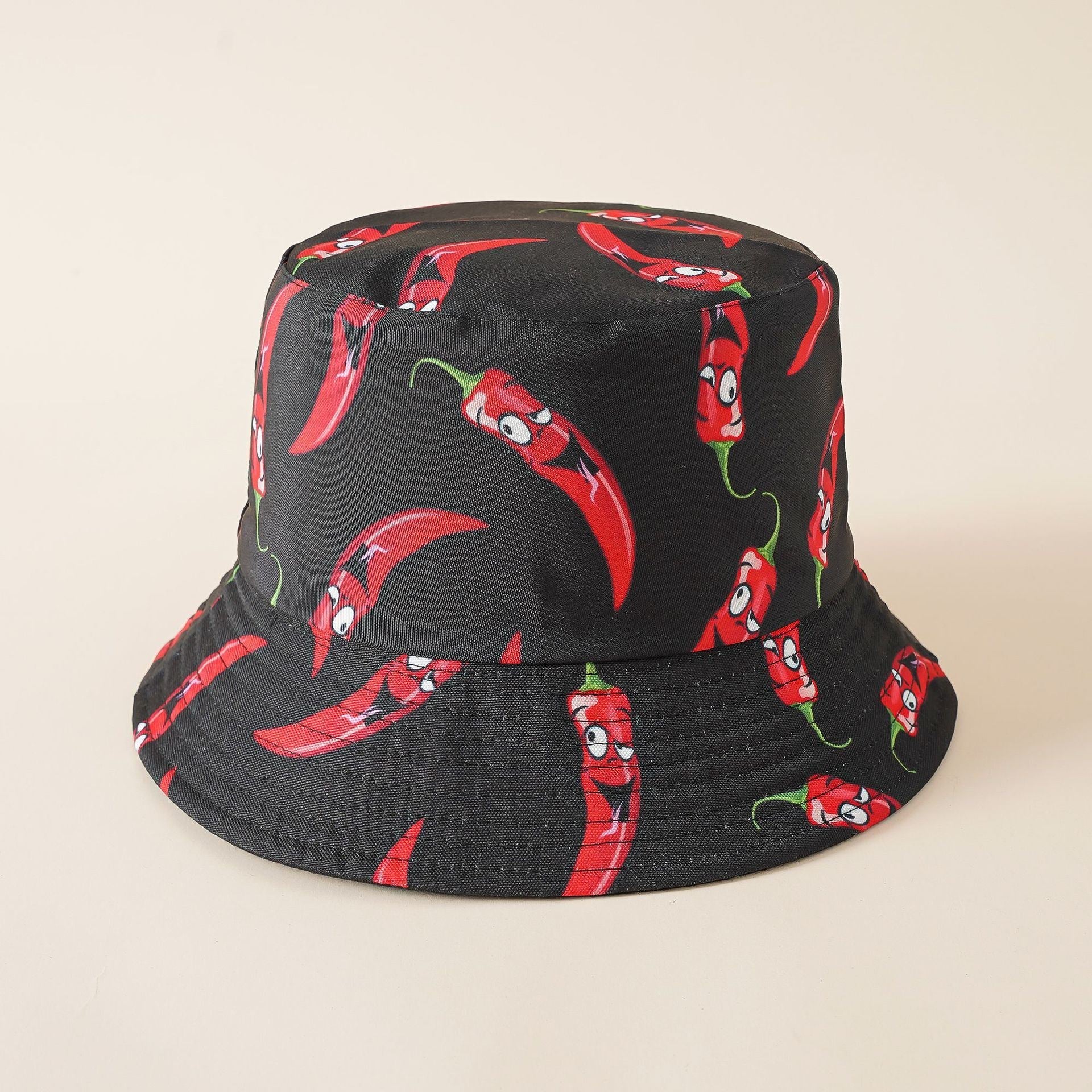 Black bucket hat with red chili pepper motif, wide brim