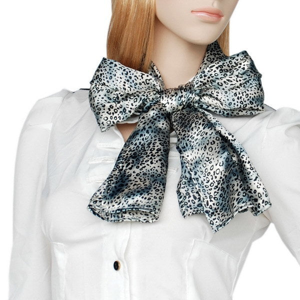 Leopard-print silk scarf in light blue with dark spots, neck-tied with loose bow