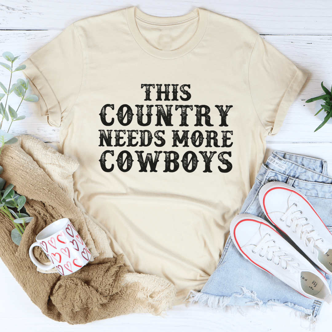 Heather dust T-shirt with 'THIS COUNTRY NEEDS MORE COWBOYS' graphic