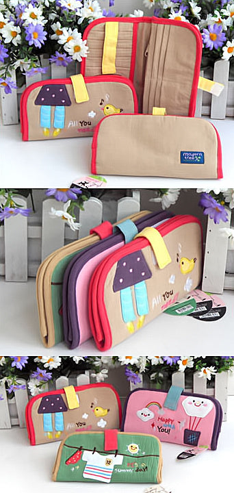Embroidered fabric wallets with applique designs, shown in multiple colors on display