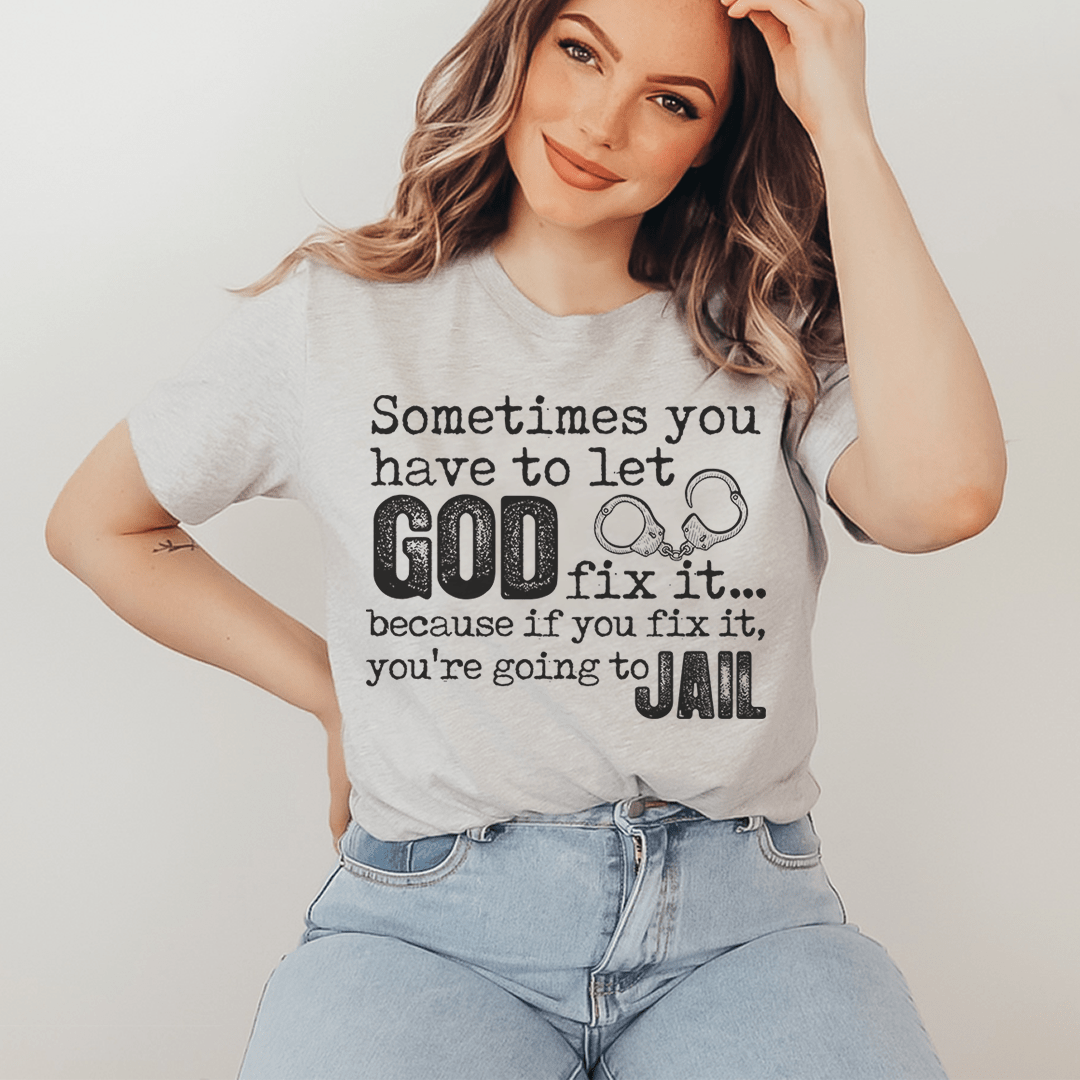 Heather gray crew-neck T-shirt with 'GOD fix it...' and 'JAIL' graphic print, worn