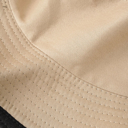 Women's beige bucket hat close-up showing eyelet-stitch brim details