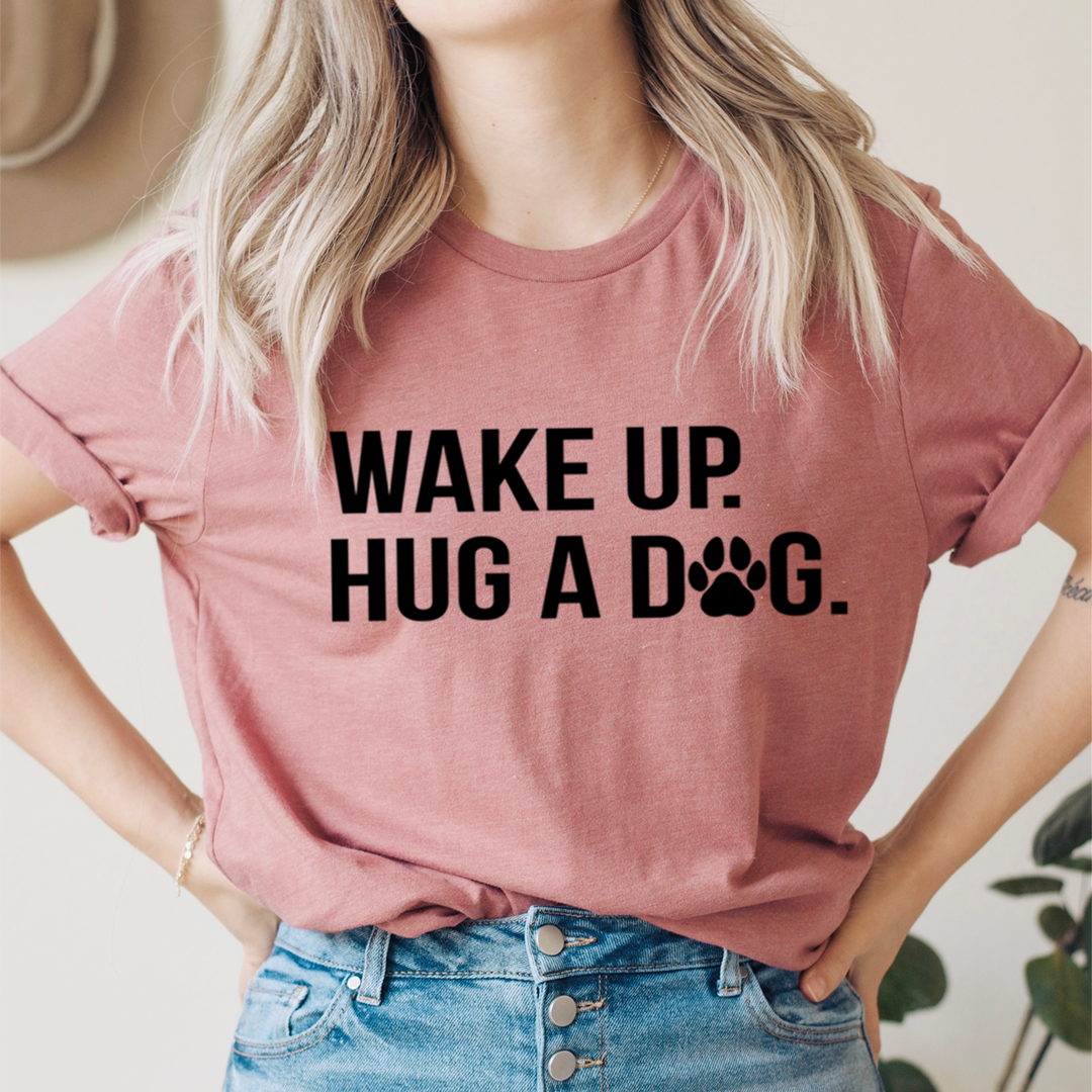 Mauve/pink T-shirt with black "WAKE UP" "HUG A DOG" print