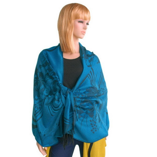 Blue pashmina shawl with dark floral pattern and fringed ends, draped on model