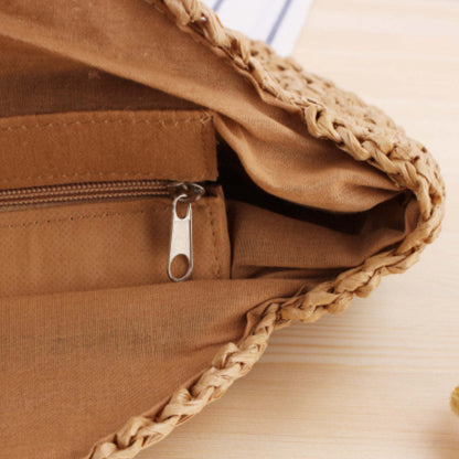 Straw tote bag open top with zipper pull and tan fabric lining