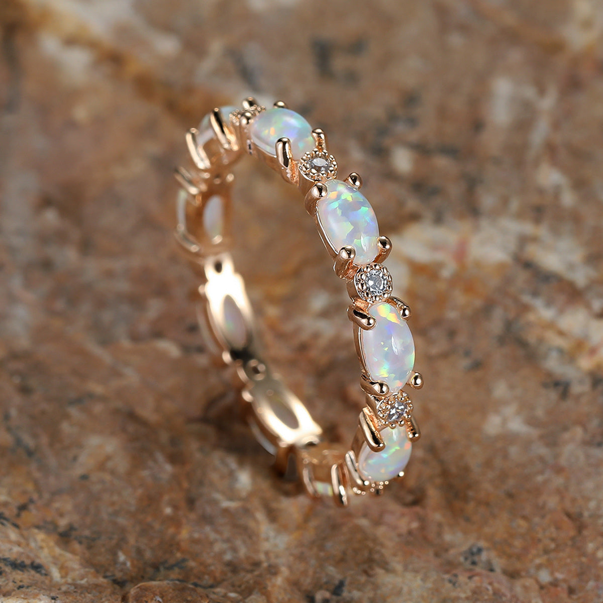 Gold-tone ring with oval opal-look stones and small round diamond accents