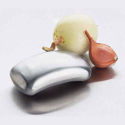 Odor remover bar with onion and garlic pieces resting beside it