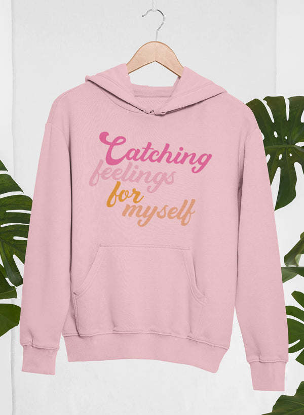 Pink hoodie with 'Catching feelings for myself' print, hood, and kangaroo pocket