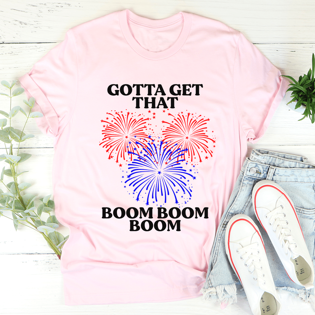 Pink crewneck T-shirt with fireworks graphic, 'GOTTA GET THAT' and 'BOOM BOOM BOOM'
