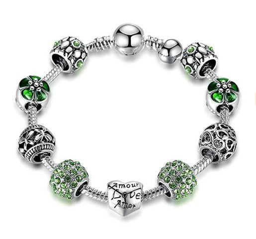 Green flower charm bracelet with silver-tone beads and heart Love charm.