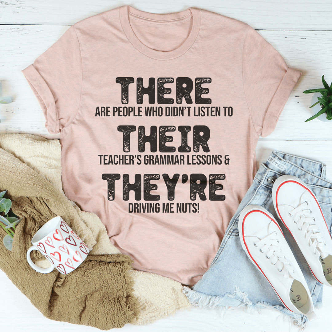 Dusty pink crewneck T-shirt with 'THERE' and 'THEY'RE' text graphic