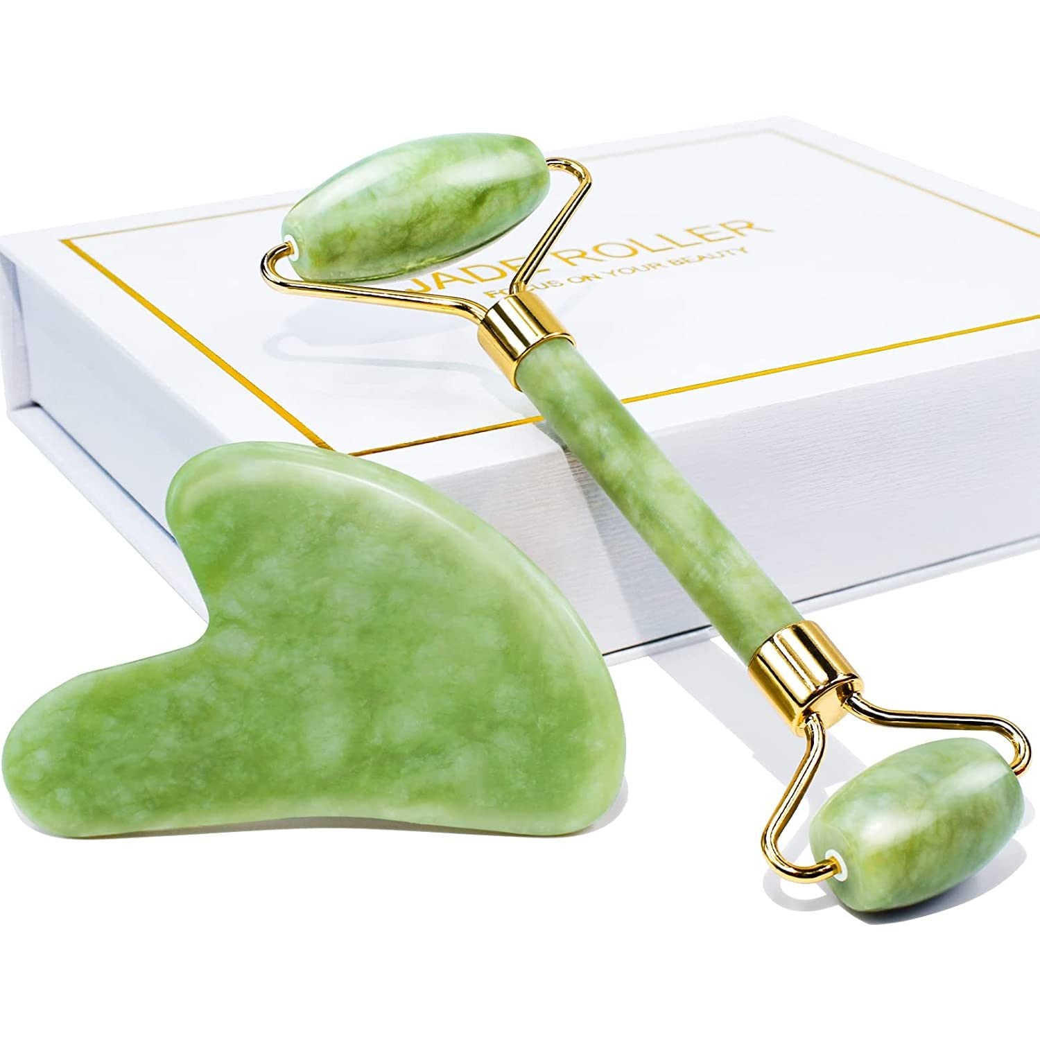 Jade roller and gua sha set in white gift box with green stones and gold handles
