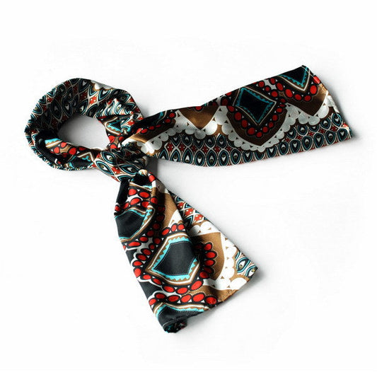 Silky scarf wrap with black base, red, teal, and white geometric patterns, laid flat.