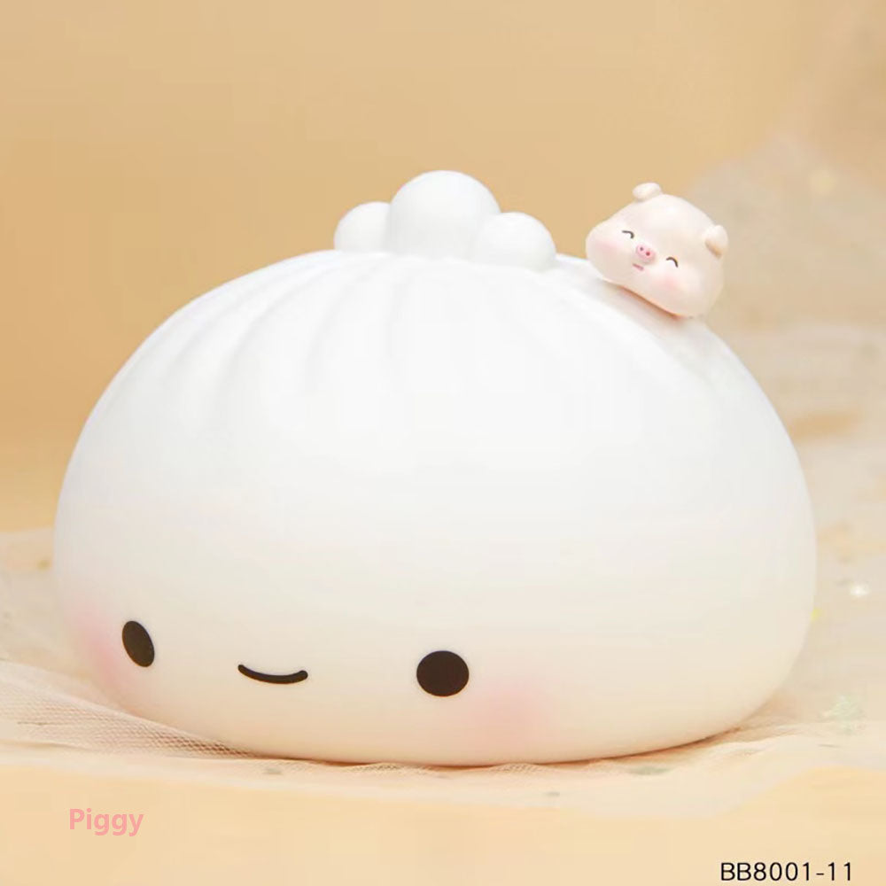 Silicone dumpling night light with white bun shape and small pig figurine on top