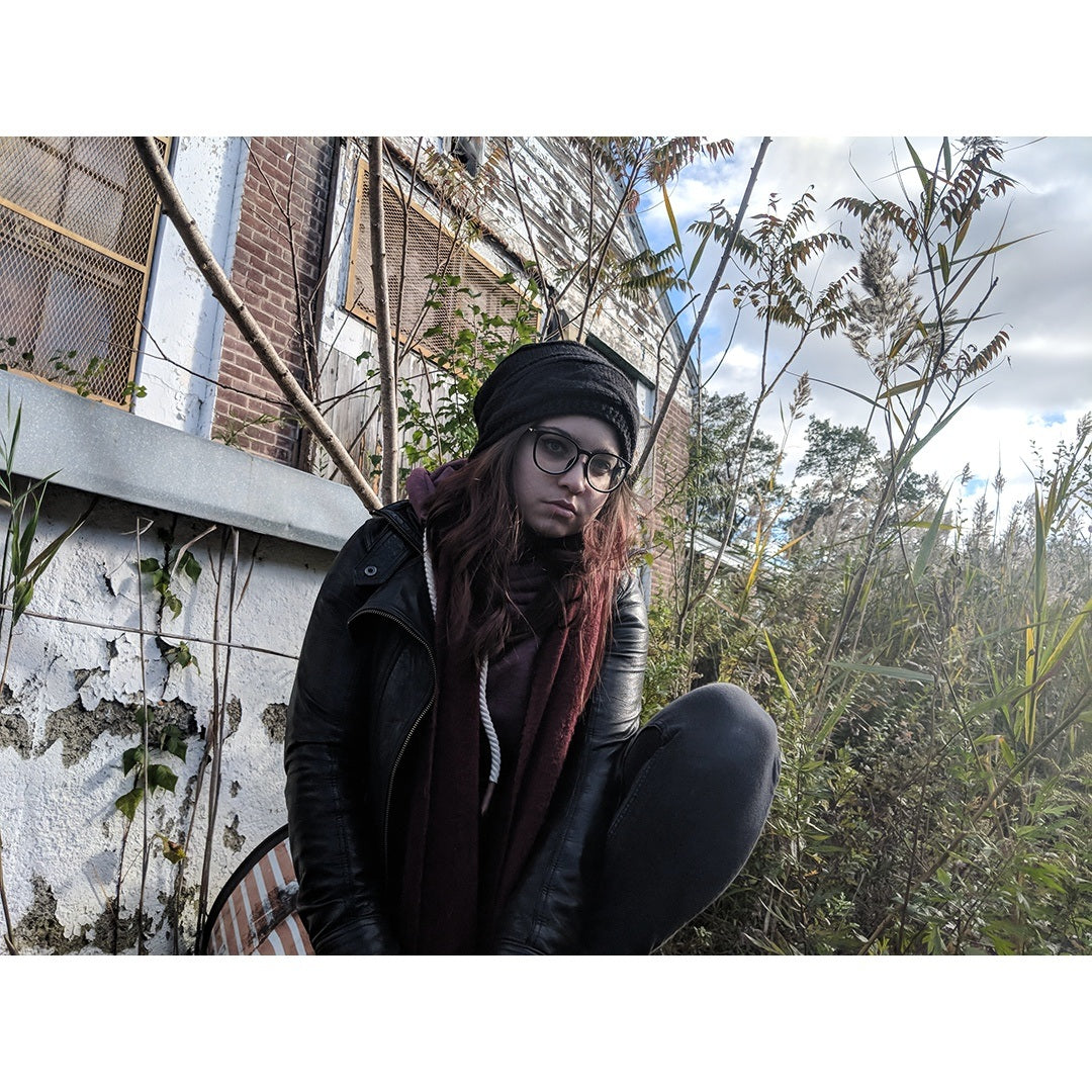 Black fleece-lined knit beanie hat with slouch fit and small logo patch