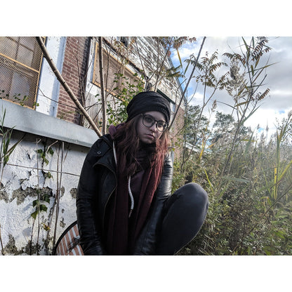 Black fleece-lined knit beanie hat with slouch fit and small logo patch