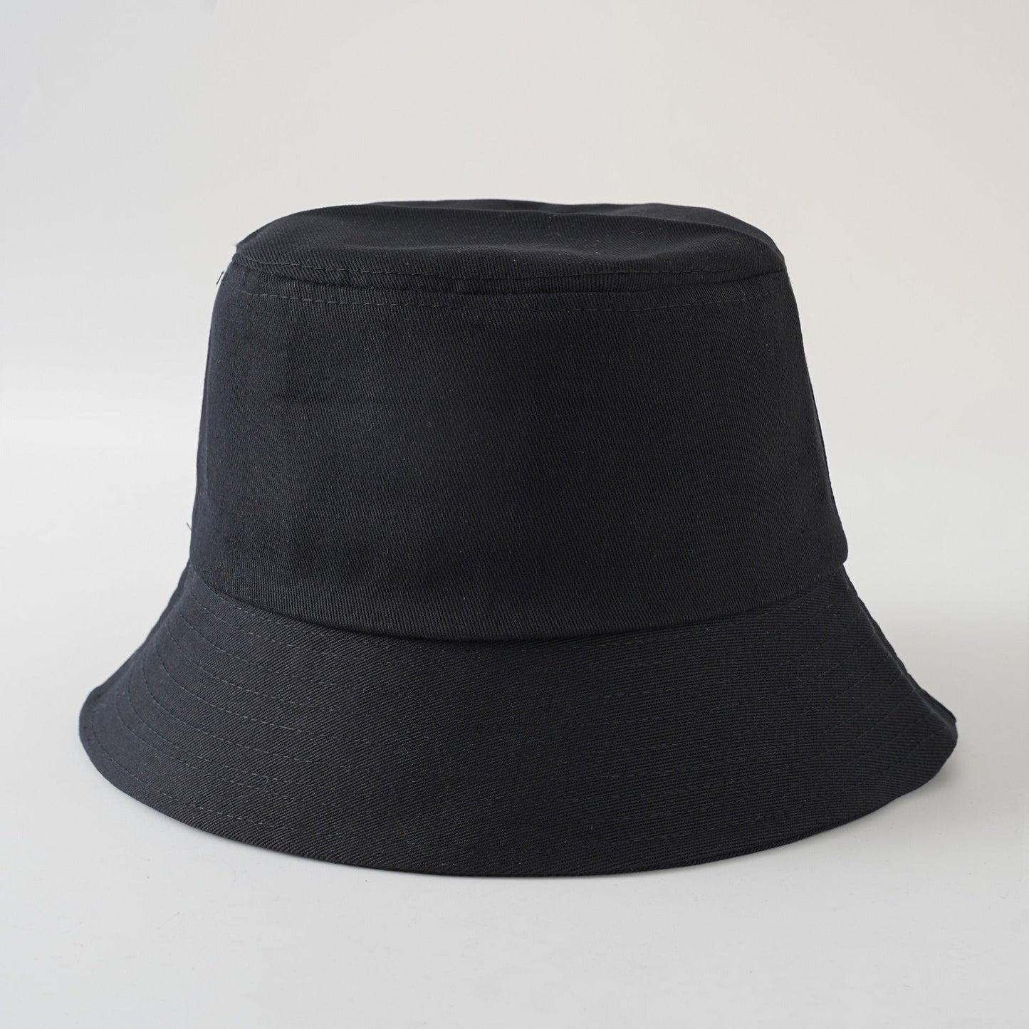 Black fisherman bucket hat, solid color with wide brim and stitched crown