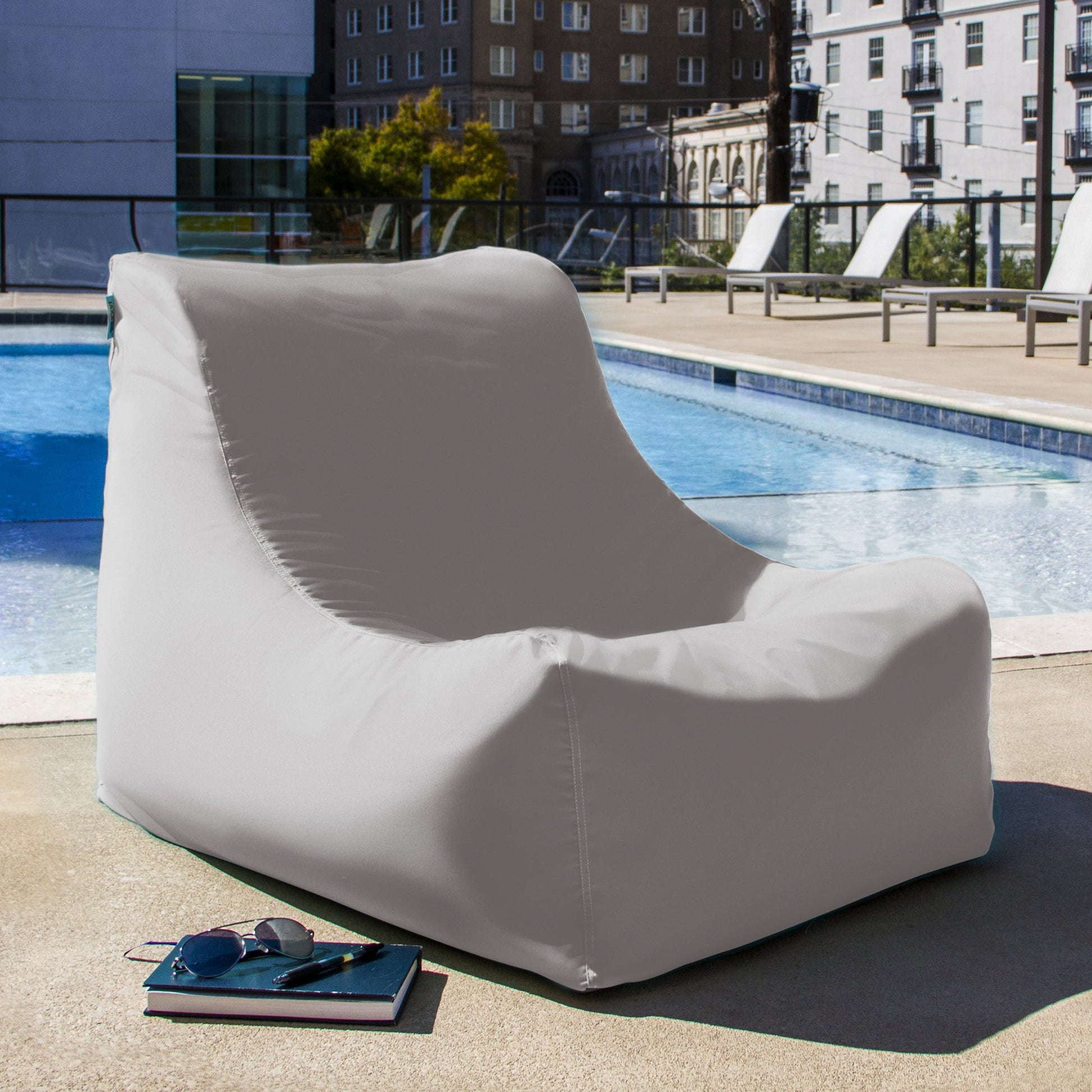 Pearl outdoor bean bag chair with relaxed curved back, light gray cover