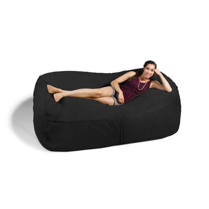 Black giant bean bag sofa with a person reclining on the side bolster