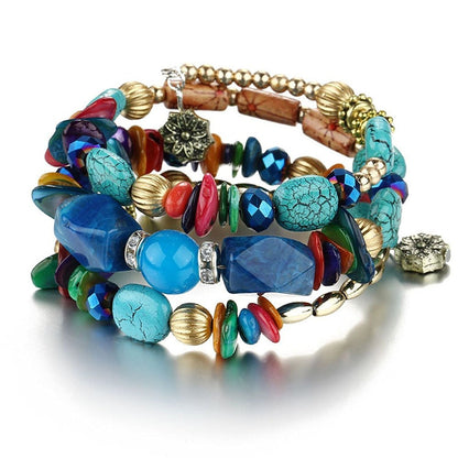 Multilayer boho charm bracelet with blue turquoise stones, red accents, and gold-tone beads