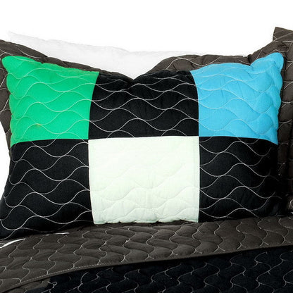 Twin quilt set with black, green, blue, white patchwork and wavy vermicelli quilting