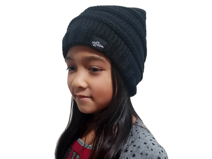 Black knit beanie hat on child with ribbed cable texture