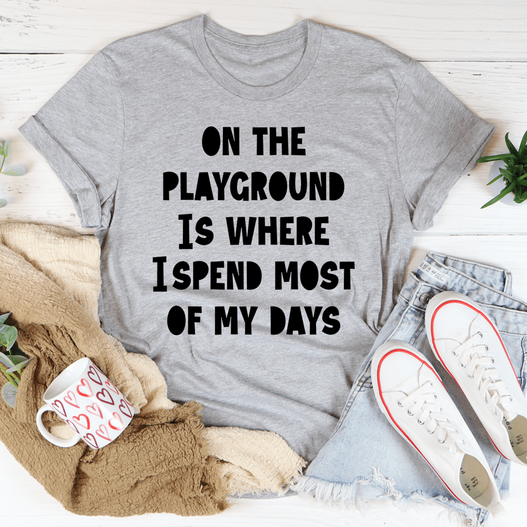Heather gray crewneck T-shirt with black text: ON THE PLAYGROUND IS WHERE I SPEND MOST
