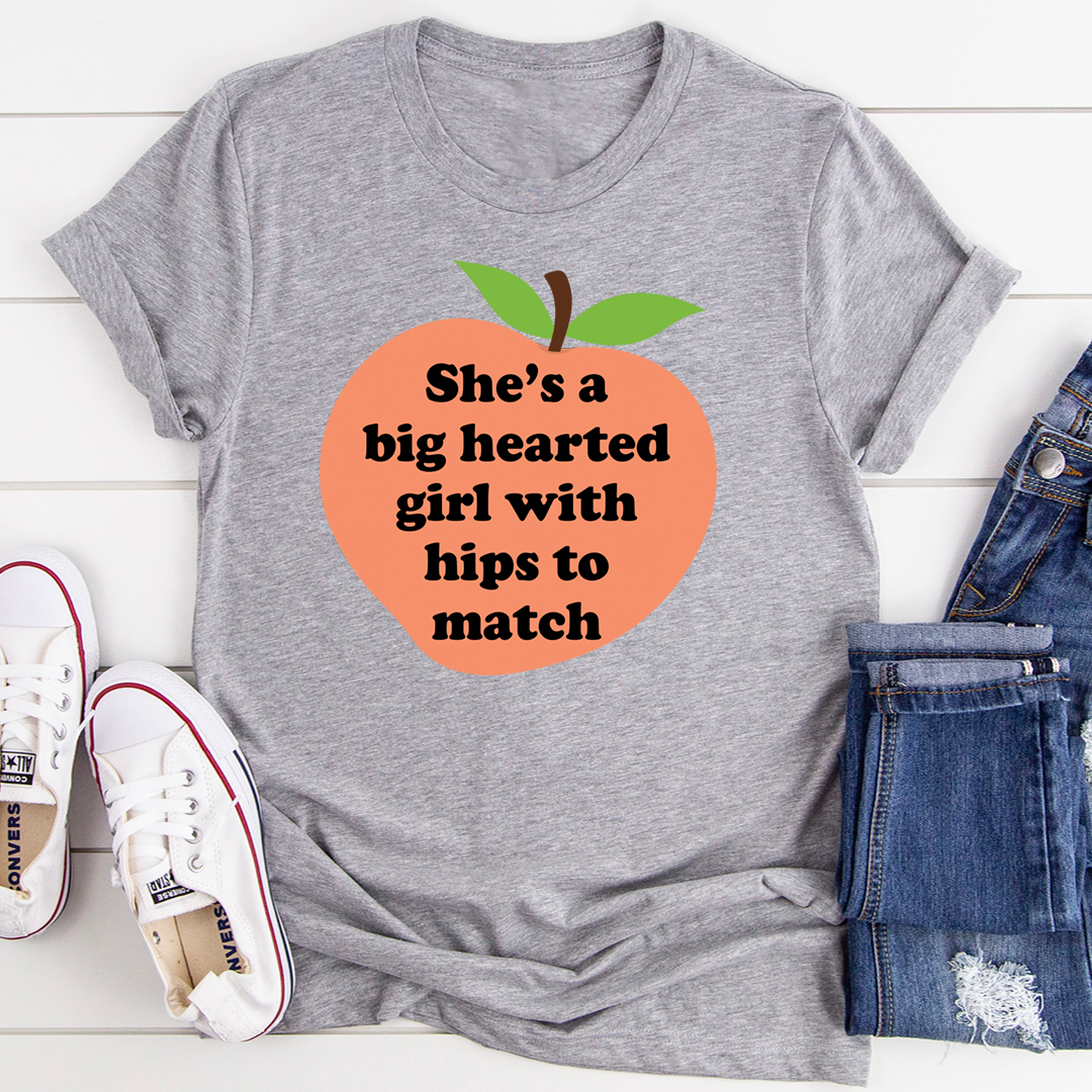 Heather gray graphic t-shirt with orange heart logo, green leaves, and “hips to match” text.